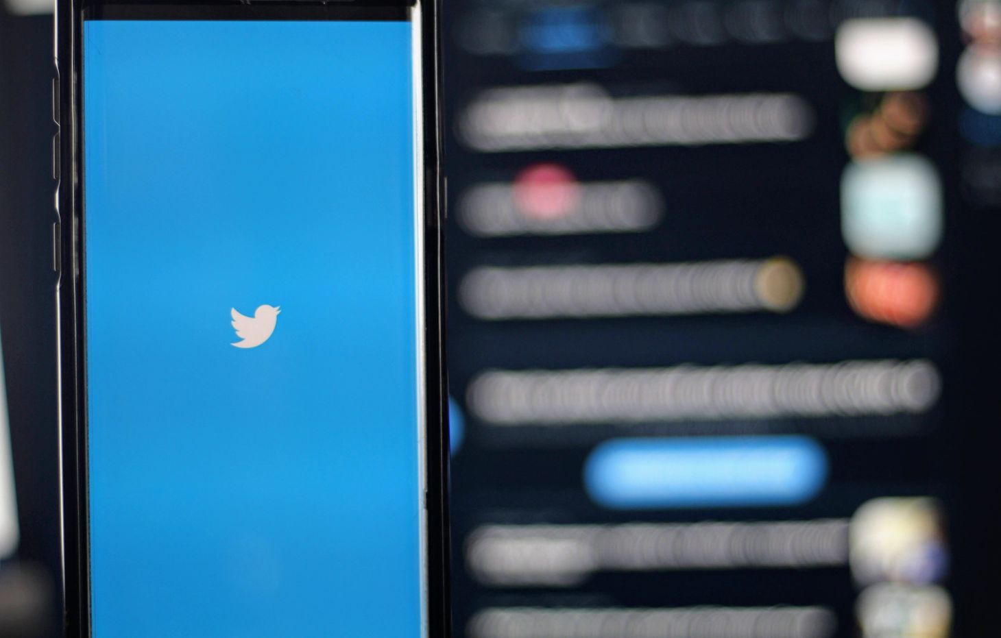 Twitter's logo on a phone.